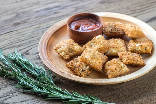 Plate with fried ravioli on the wooden board — Stock Photo, Image