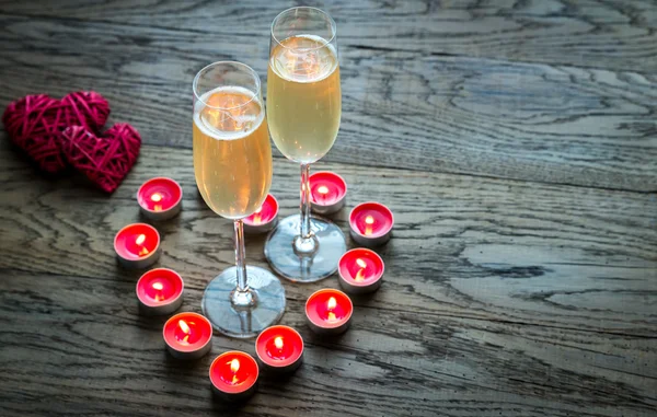 Två glas champagne i brinnande ljus — Stockfoto