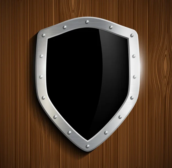 Metalen shield op een houten oppervlak — Stockvector