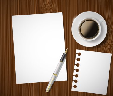 bir kağıt yaprağına ve bir fincan kahve ahşap bir masa üzerinde