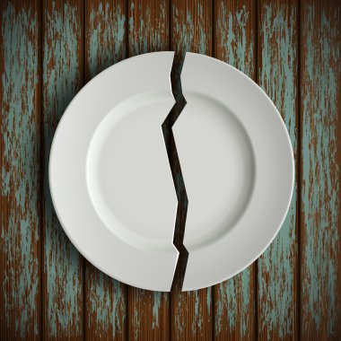 broken white plate on old wooden table clipart