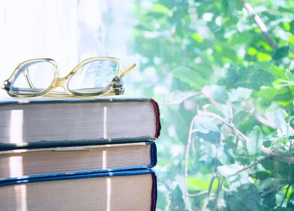 Reading glasses lying on an books — Stock Photo, Image