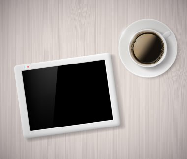 Fincan kahve ve bir dijital tablet masada