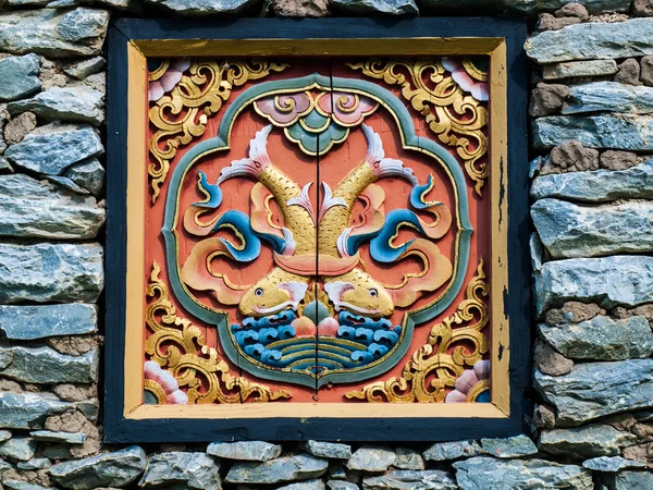 Bhutan traditional wooden decoration in rock wall — Stock Photo, Image