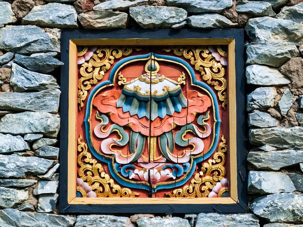 Bhutan traditional wooden decoration in rock wall — Stock Photo, Image