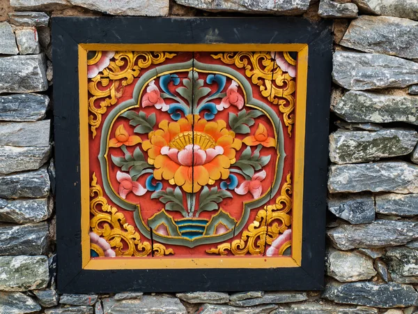 Bhutan traditional wooden decoration in rock wall — Stock Photo, Image