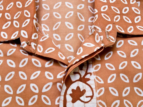 Brown batik with the repettition pattern shirt from Yogyakarta, — Stock Photo, Image