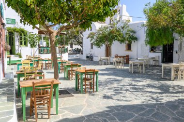 Folegandros, Yunanistan - 23 Eylül 2020: Folegandros Adası 'ndaki kilise ve restoranların bulunduğu küçük bir meydan. Cyclades, Yunanistan