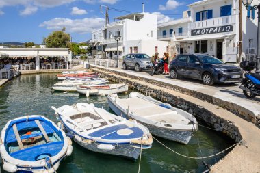 Paros, Greece - September 27, 2020: Coastal promenade in Aliki harbor. Aliki is beautiful coastal village with a picturesque port on Paros Island. Cyclades, Greece