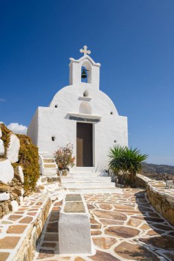 Ios Adası 'ndaki Chora şehir merkezindeki bir tepenin üstünde küçük beyaz bir şapel. Cyclades, Yunanistan