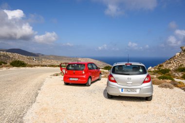 Ios, Yunanistan - 21 Eylül 2020: Opel Corsa ve Seat Mii Ios Adası 'nın doğu yakasındaki yolda. Cyclades, Yunanistan