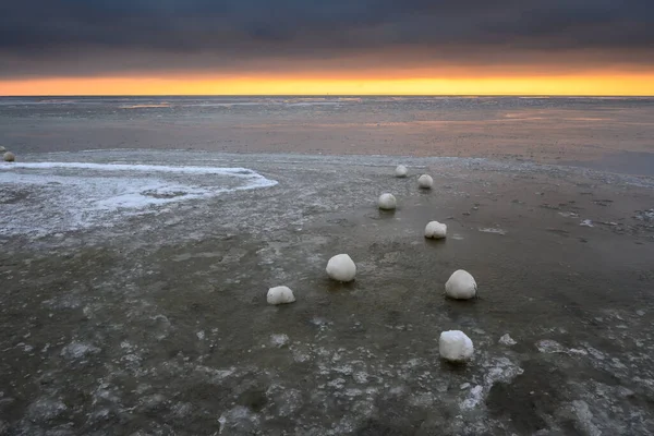 Frozen ice balls on the beach in Jastarnia during winter. Hel Peninsula, Poland