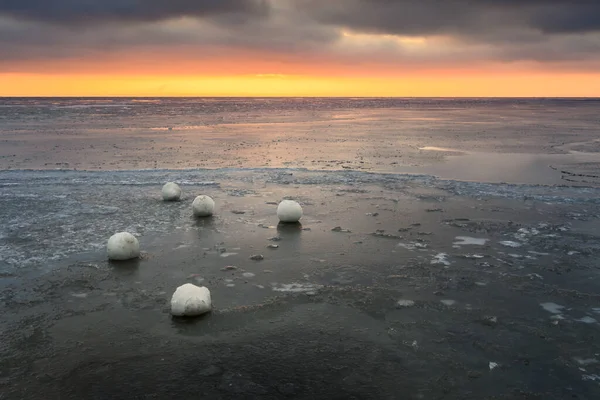 Frozen ice balls on the beach in Jastarnia during winter. Hel Peninsula, Poland