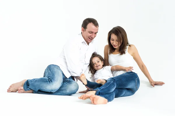 Young loving family: mother, father and daughter in a bright interior — Stock Photo, Image
