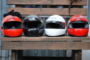 dört kask yarış yarış pistine yakın bir bankta vardır