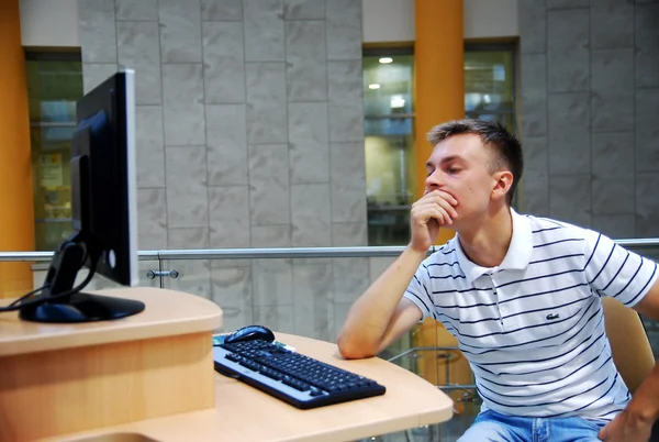 The young guy at the computer while working