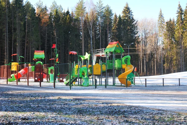 A children's playground in the park under the first snow — Stock Photo, Image