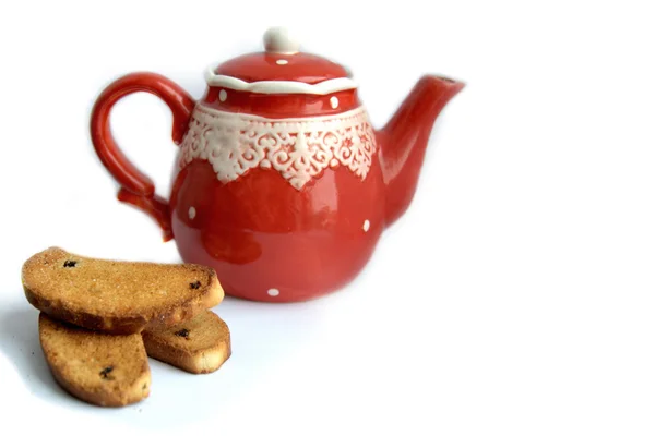 Red ceramic teapot and cookies on a white table — Stock Photo, Image