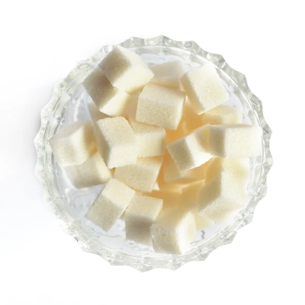 Pieces of cube sugar in crystal sugar bowl on a white background — Stock Photo, Image