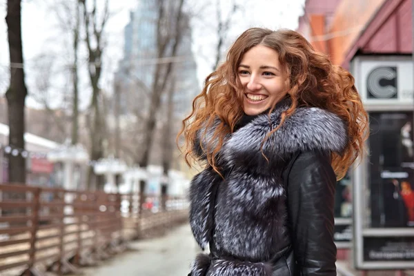 Cheerful smiling girl with red curly hair — Stock Photo, Image