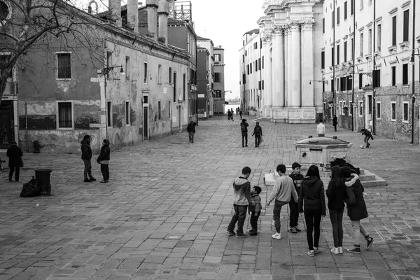 People walk on the square in the center of Venice