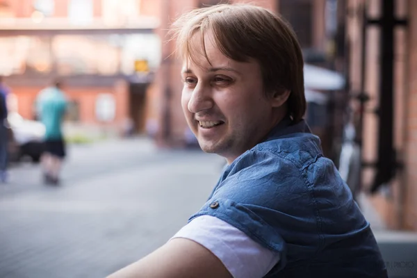 The young man sits on the stairs and smiles — Stock Image The young man sits on the stairs and smiles Royalty Free Stock Photos