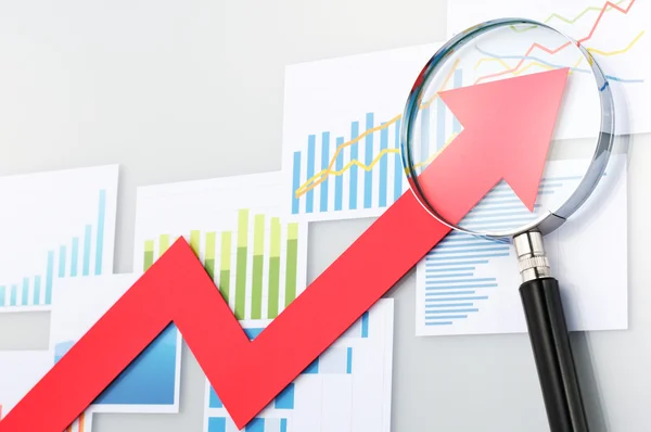 Looking upside growth arrow with magnifying glass. Graphs and da — Stock Photo, Image