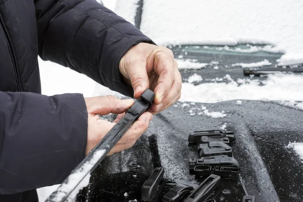 Windshield broken wiper blades replacement, winter scene