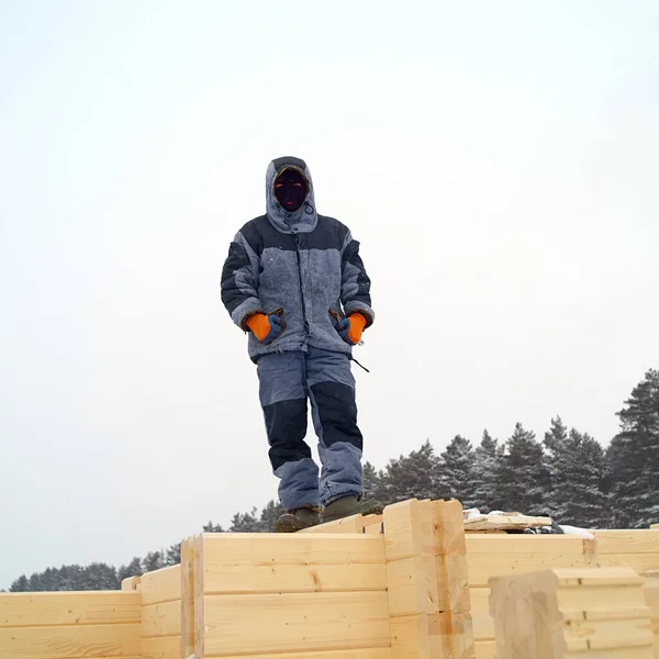 a worker wearing protective mask posing in construction area, winter scene