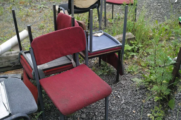 Collection of discarded old office chairs, outdoor shot without people