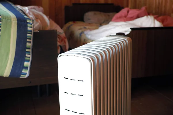 Electric heater in a messy empty bedroom, indoor cropped image