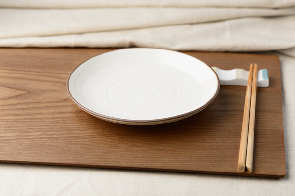 Empty dish and chopsticks