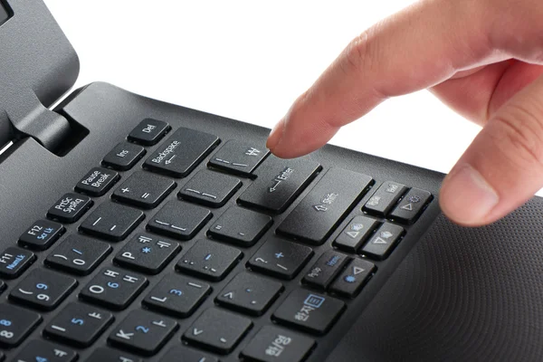 Laptop keypad with index finger pressing enter key — Stock Photo, Image