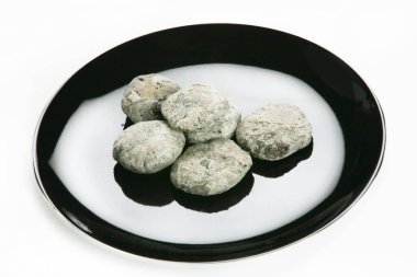 delicious dessert on black plate on white background