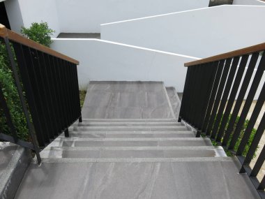 concrete staircase with a white wall 
