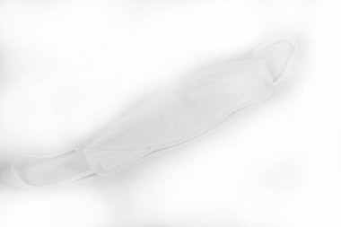 white disposable mask on a light background 