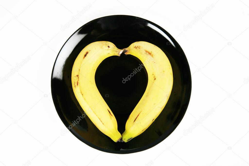 banana on black plate on a white background