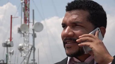 Baz istasyonu yakınındaki cep telefonuyla konuşan adam