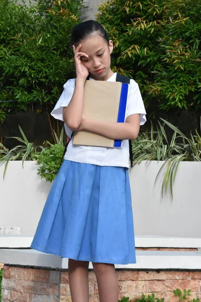 Female Student And Worry With Books Standing