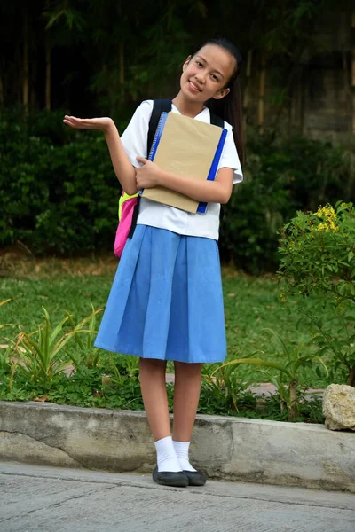 School Girl Making A Decision With Books Standing