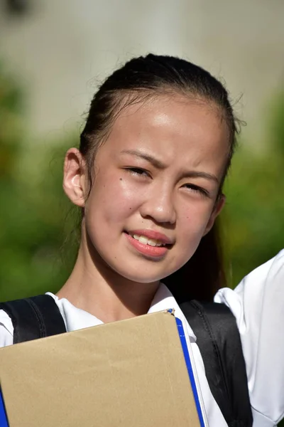 Youthful Minority Female Student Smiling With Notebooks