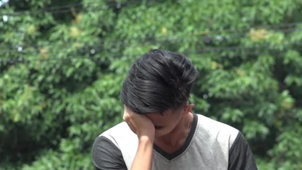Un cansado estresado adolescente asiático masculino — Vídeo de stock