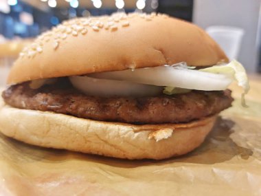 A Hamburger Patty Bun And Onion