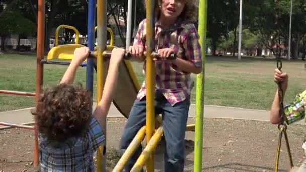 Brothers Playing on Swing Set — Stock Video