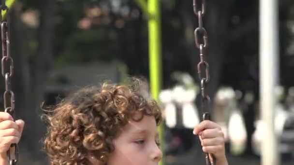 Boy Swinging on Swing Set — Stock Video