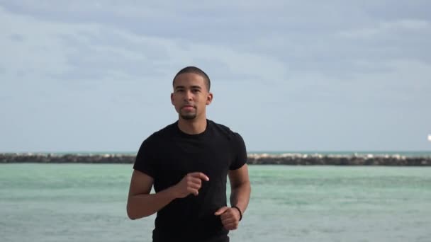 Homme jogging près de l'océan — Video