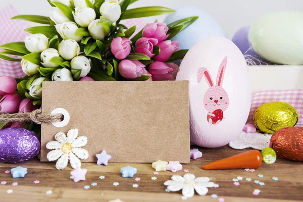 Blank paper tag and easter decoration on wooden background — Stock Photo, Image