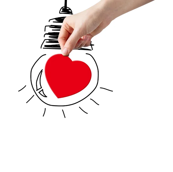 Hand picking paper heart and bulb sketch — Stock Photo, Image