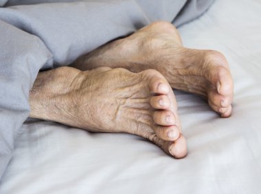 Old feet on the bed clipart