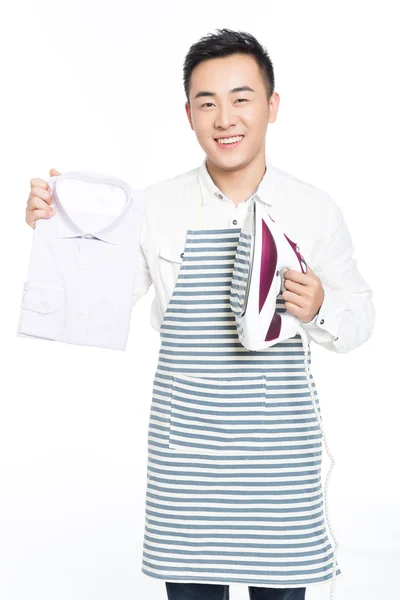 Chinese young man ironing his clothes — Stock Photo, Image